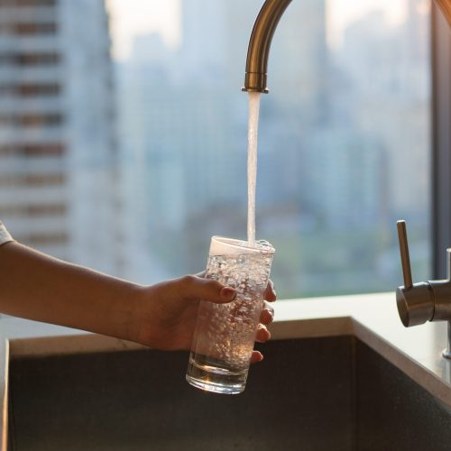 Girl,Fills,A,Glass,With,Clean,Filtered,Tap,Water,For